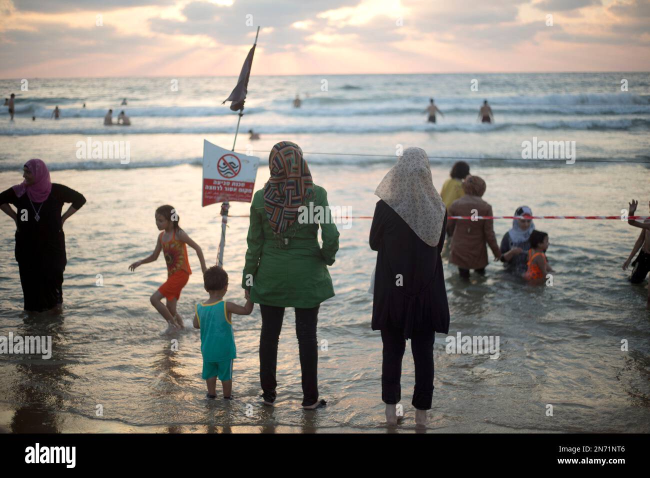 Palestinian Muslim women bathe in the Mediterranean sea in Jaffa, a