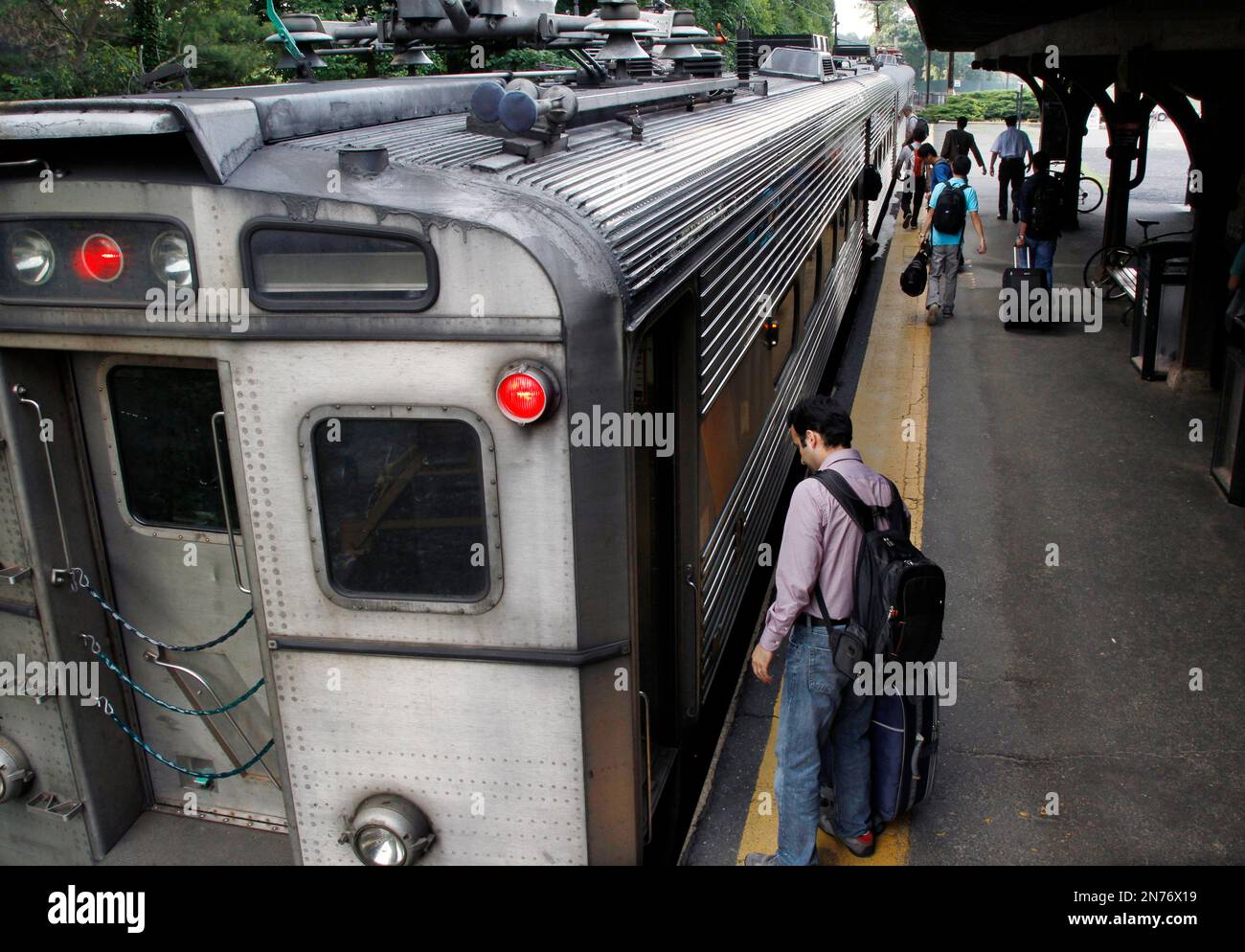In this Saturday, June 29, 2013 photo, people board Princeton's Dinky