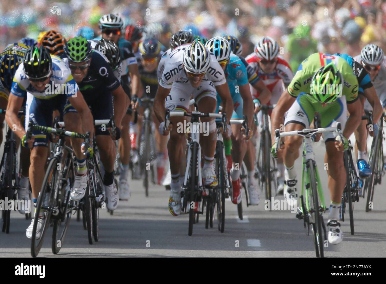 Australia's Simon Gerrans, left, crosses the finish line ahead of Peter Sagan of Slovakia, right and second place, Jose Joaquin Rojas of Spain, second left and third place, and Belgium's Philippe Gilbert, center in white and fifth place, to win the third stage of the Tour de France cycling race over 145.5 kilometers (91 miles) with start in Ajaccio and finish in Calvi, Corsica island, France, Monday July 1, 2013. (AP Photo/Laurent Rebours) Stockfoto