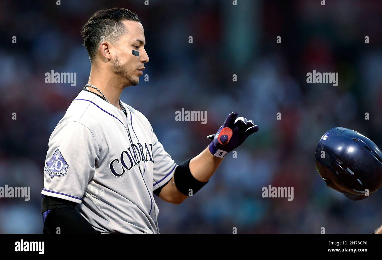 Colorado Rockies' Carlos Gonzalez tosses his helmet after flying out to end the third inning of a baseball game against the Boston Red Sox at Fenway Park in Boston on Tuesday, June 25, 2013. (AP Photo/Winslow Townson) Stockfoto