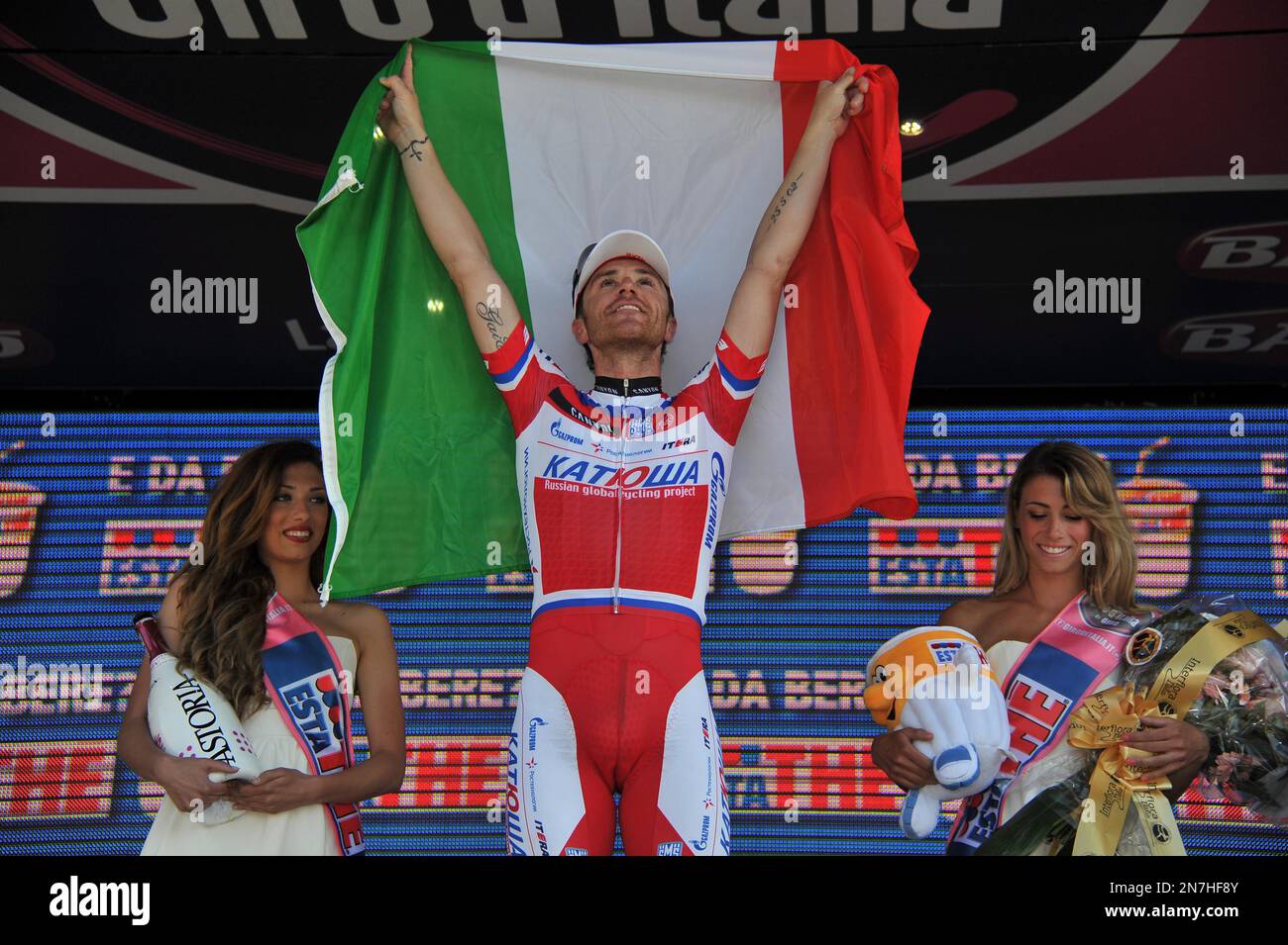 Italy's Luca Paolini celebrates on the podium after winning the third