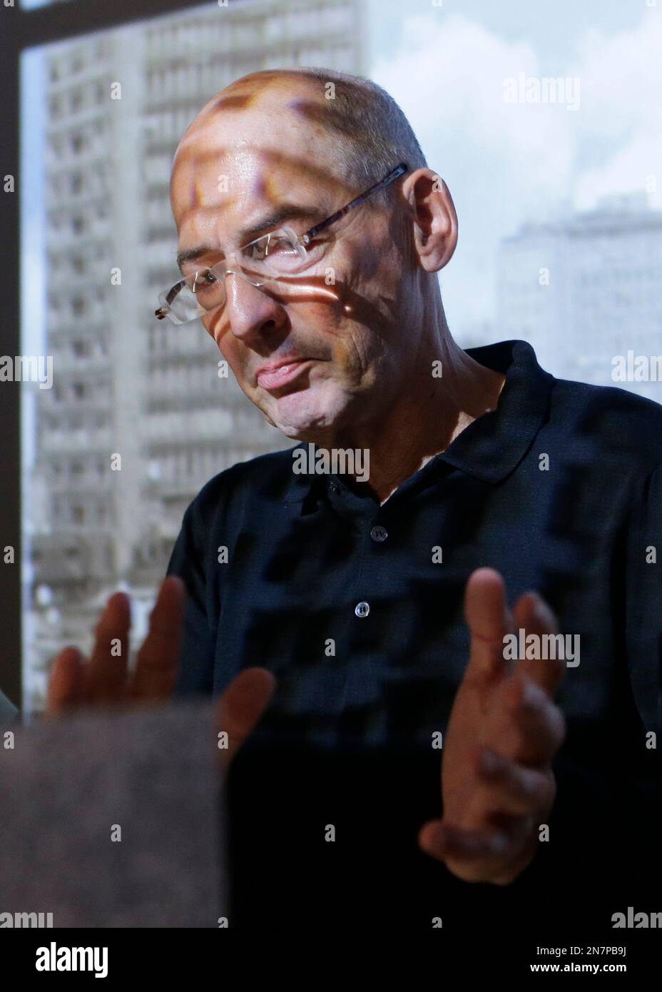 Dutch architect Rem Koolhose gestures at the Knoll company furniture space, part of the Milan's