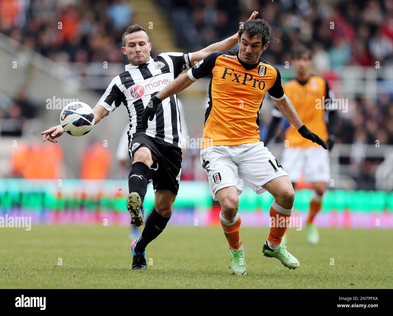 Newcastle United's Captain Yohan Cabaye of France, left, vies for the ball with Fulham's Greek player Giorgos Karagounis, right, during their English Premier League soccer match at St James' Park, Newcastle, England, Sunday, April 7, 2013. (AP Photo/Scott Heppell) Stockfoto
