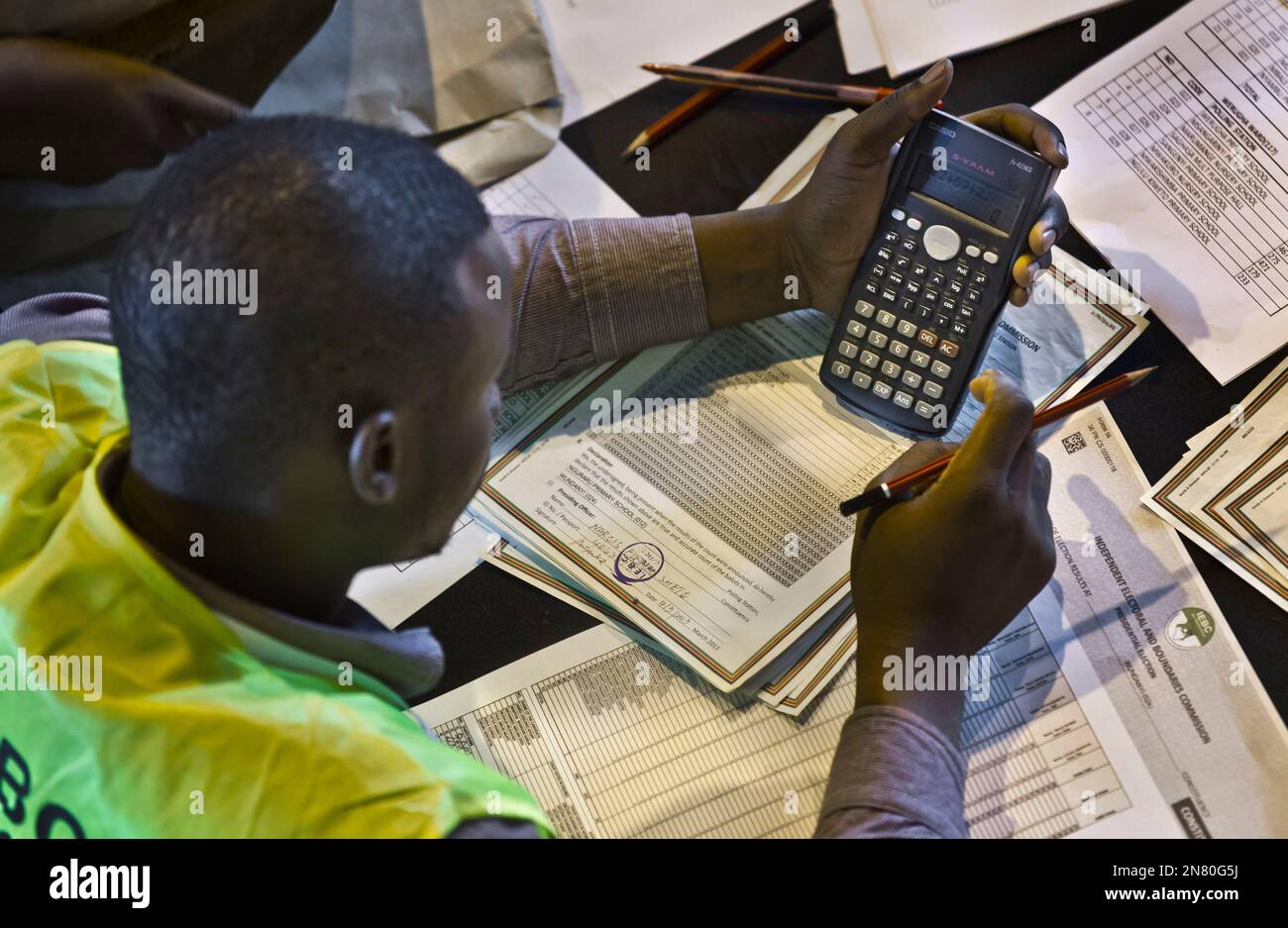 An electoral worker engages in a part of the tally verification process