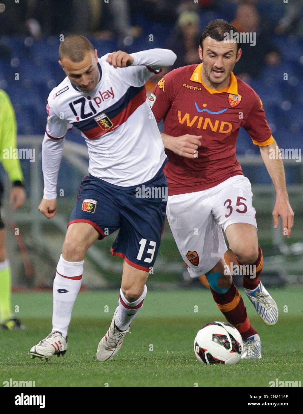 Genoa defender Luca Antonelli, left, and AS Roma's Vasilis Torosidis of Greece fight for the ball during a Serie A soccer match between As Roma and Genoa, in Rome's Olympic stadium, Sunday, March 3, 2013. (AP Photo/Andrew Medichini) Stockfoto