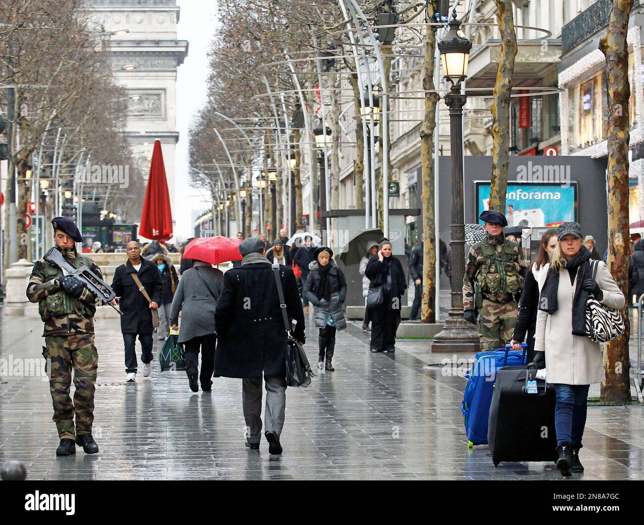 French army soldiers patrol down the Champs Elysee in Paris, Tuesday