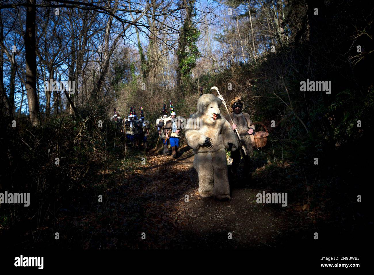 so-called-zamarracos-march-with-bells-as-they-follow-a-man-dressed-as