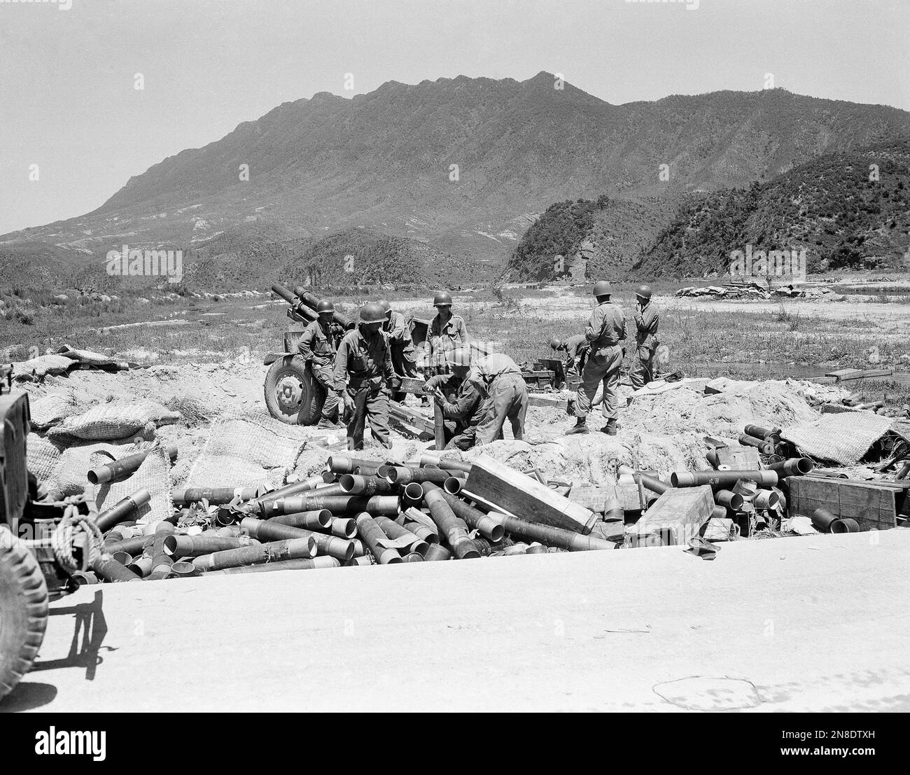 Howitzer Shell Fuse A member of the artillery crew of a 105mm howitzer sets the fuse on a ...