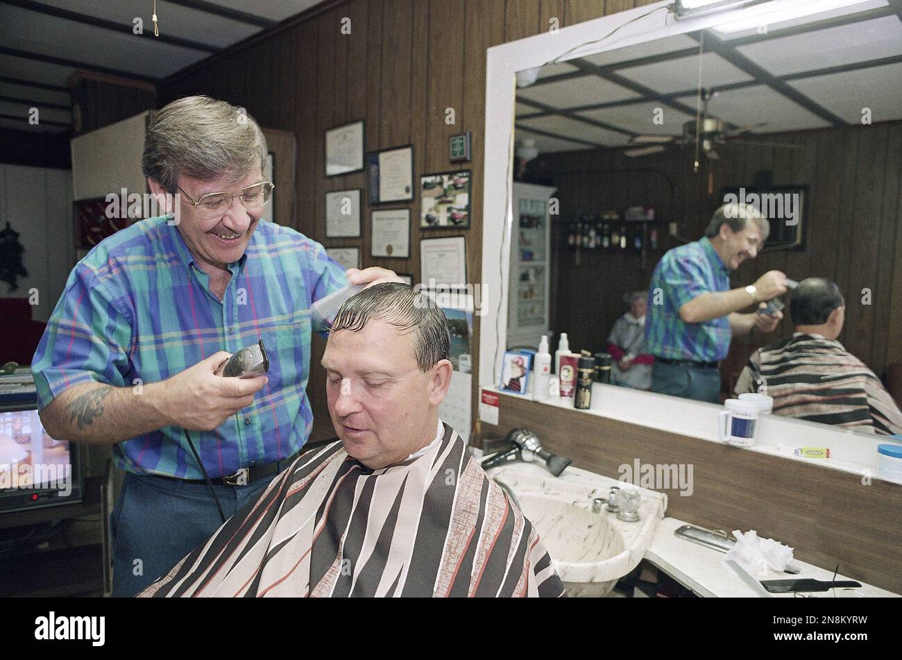 Dennis Simpson gives a haircut to Merlyn West at Simpson's Dexter, Iowa