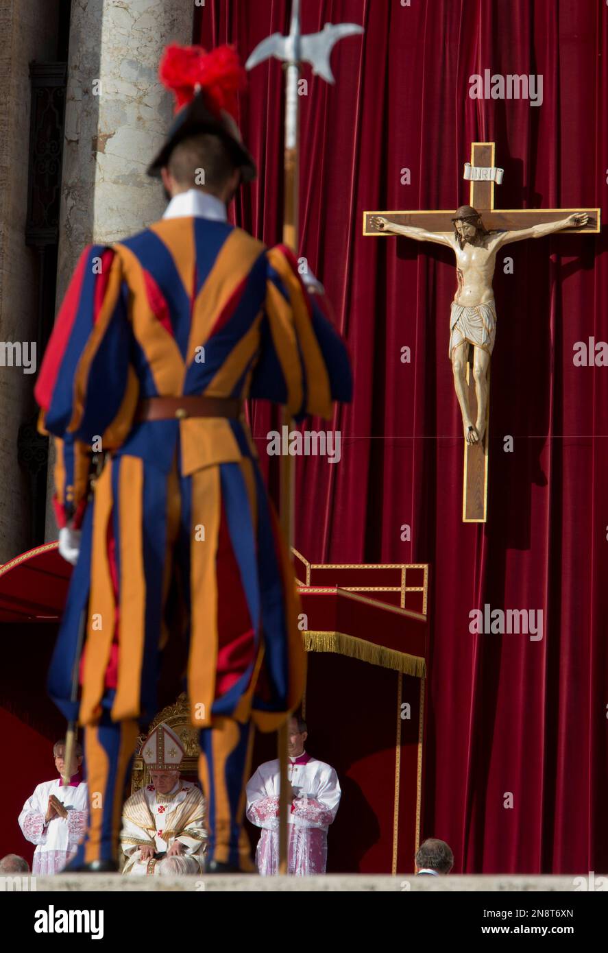 Pope Benedict XVI is framed by a Swiss Guard as he celebrates a