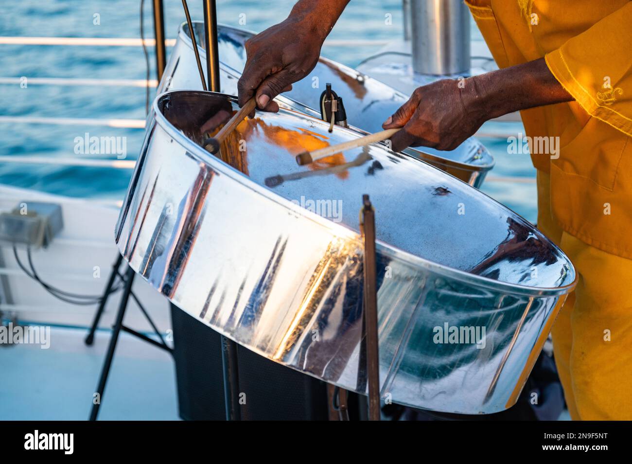 Nahaufnahme eines Musikers aus Jamaika, der auf dem offenen Deck eines Touristenboots in Key West, Florida, Stahlpfanntrommeln spielt. Stockfoto