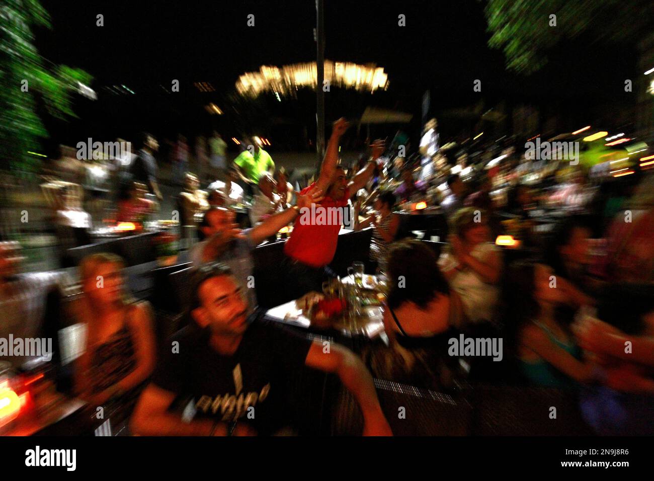 A man, center, celebrates the first goal of Greece during the game between Germany vs Greece in Athens, late, Friday, June 23, 2012. Germany beat the Greece 4-2. (AP Photo/Petros Karadjias) Stockfoto