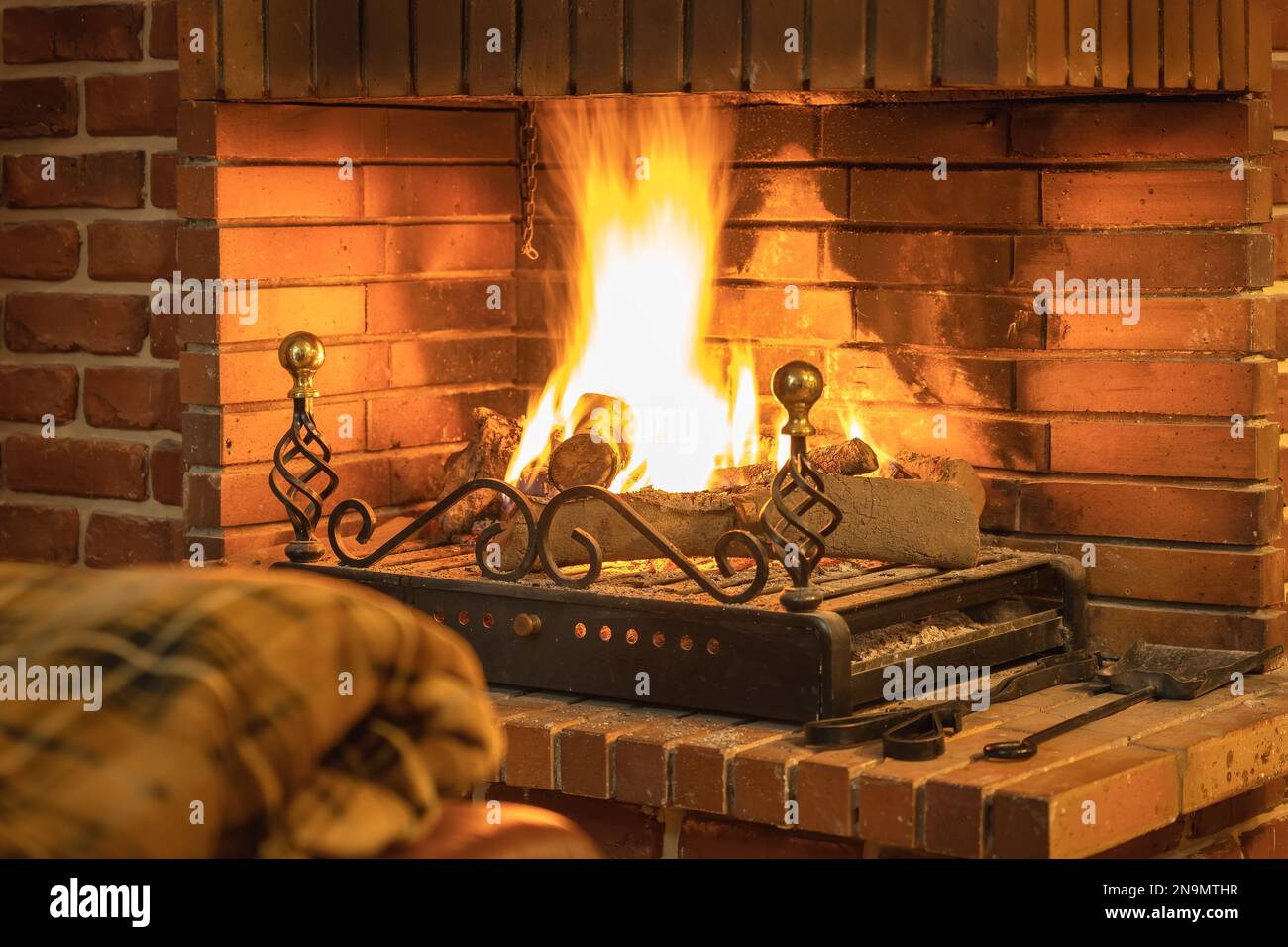 Decke, die sich vor dem gemütlichen Kamin im Haus warm hält. Stockfoto