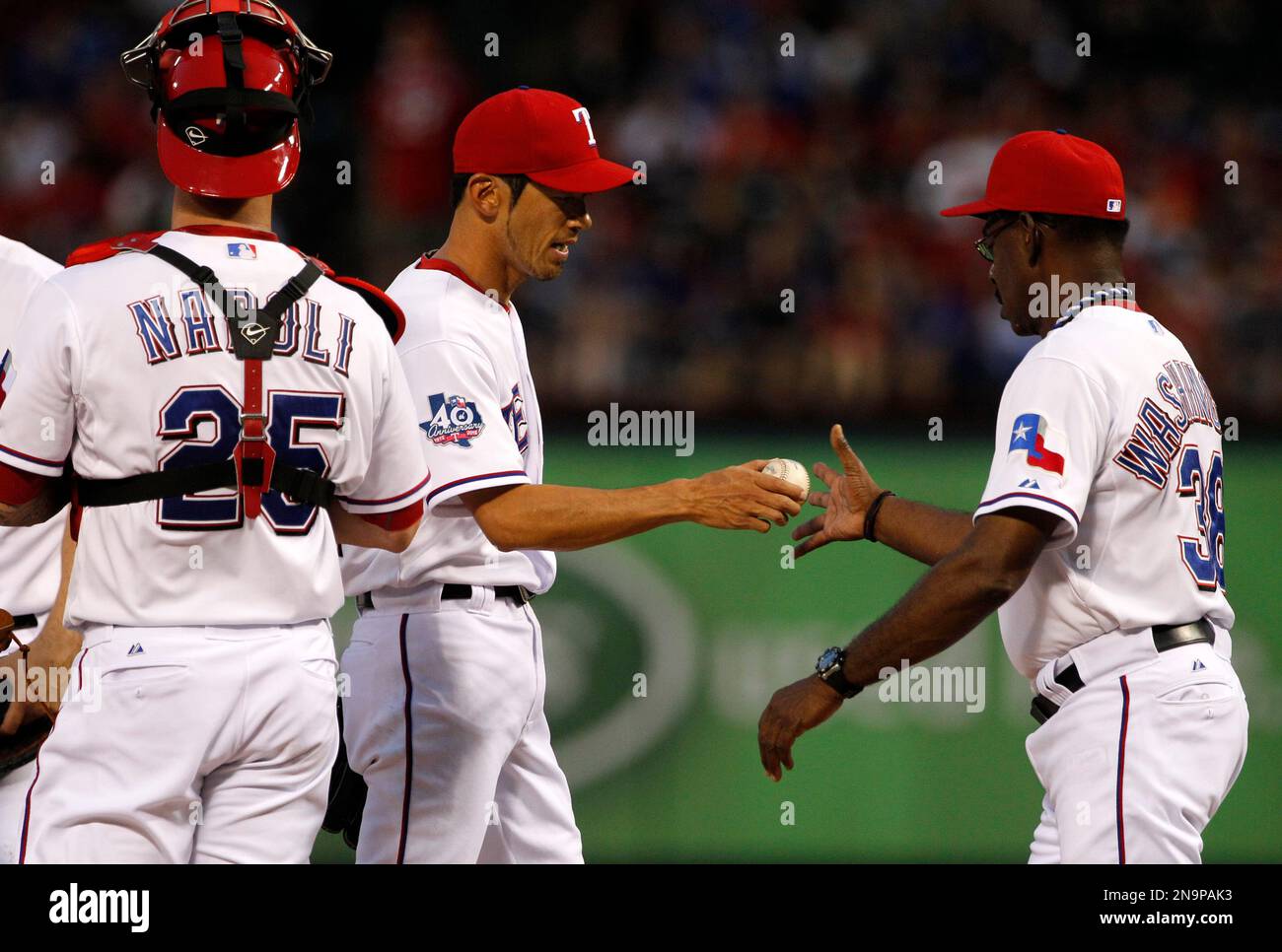 Texas Rangers catcher Mike Napoli (25) watches as relief pitcher Yoshinori Tateyama, center, of Japan is pulled by manager Ron Washington in the third inning of baseball game against the Seattle Mariners Wednesday, May 30, 2012, in Arlington, Texas. (AP Photo/Tony Gutierrez) Stockfoto