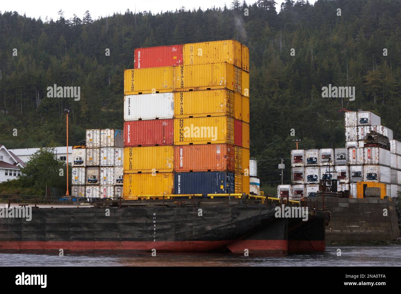 Lastkähne mit Containern warten in Ketchikan Harbor, Alaska, USA; Ketchikan, Alaska, Vereinigte Staaten von Amerika Stockfoto