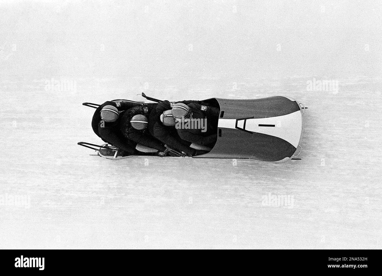 The Austrian number one four-man bob team with Erwin Thaler, Adolf Koxeder, Josef Nairz and Reinhold Durnthaler at speed on the bobsleigh run at the Winter Olympic Games in Igls, southeast of Innsbruck on Feb. 7, 1964. They won the silver Olympic medal. (AP Photo) Stockfoto