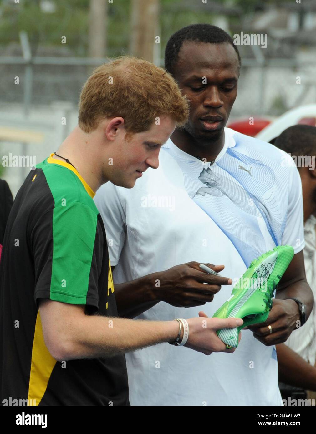 Olympic sprint champion Usain Bolt, right, presents Britain's Prince