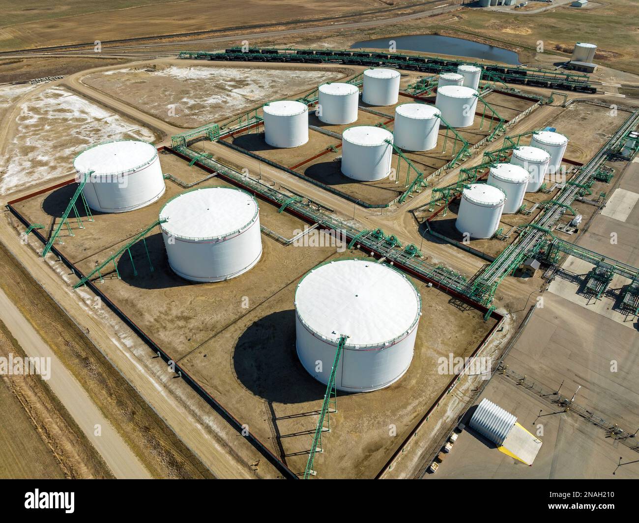 Aus der Vogelperspektive der großen runden Metallöllagertanks mit Rohrleitungen, die sie verbinden, westlich von Carseland, Alberta, Kanada Stockfoto