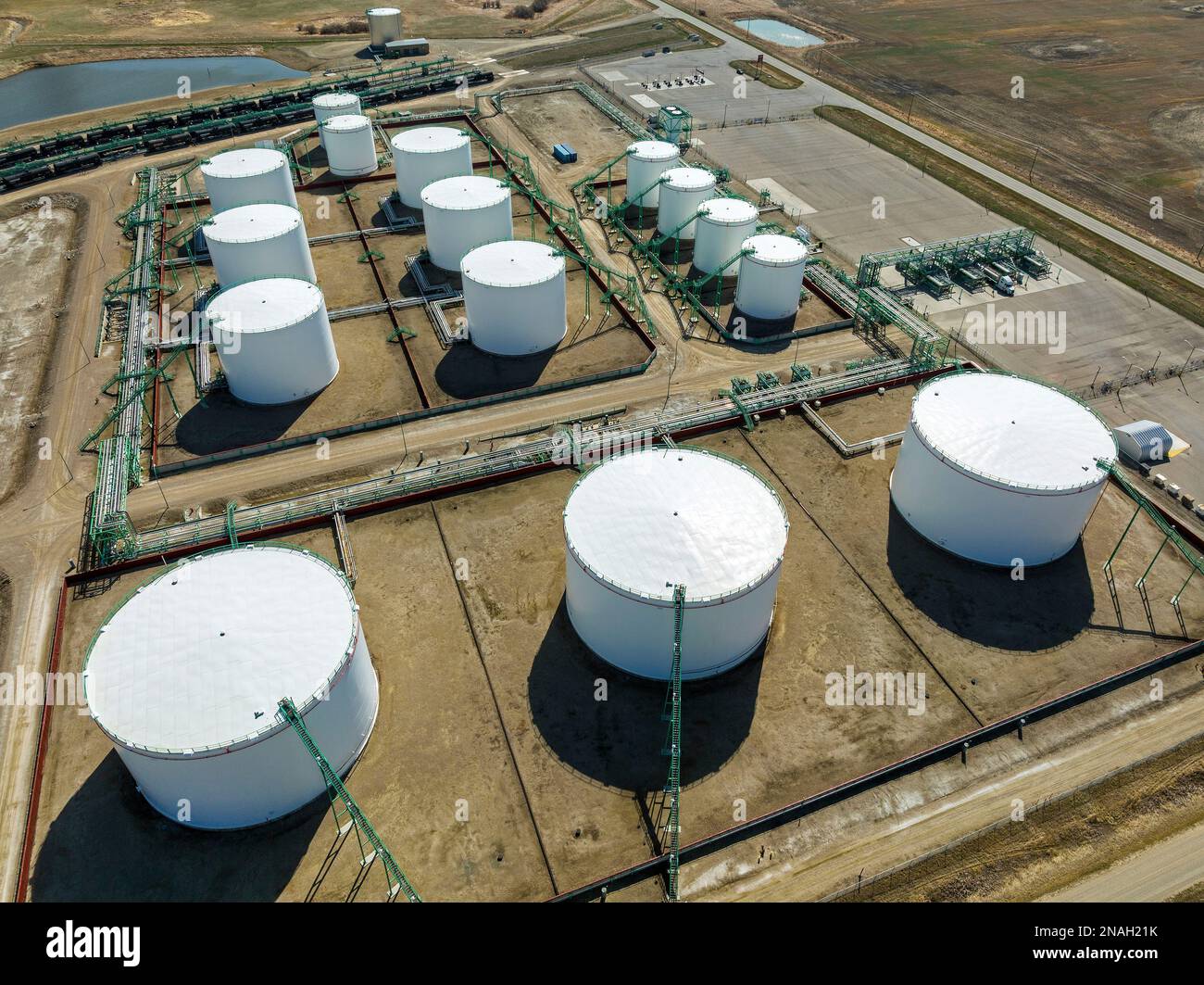 Aus der Vogelperspektive der großen runden Metallöllagertanks mit Rohrleitungen, die sie verbinden, westlich von Carseland, Alberta, Kanada Stockfoto