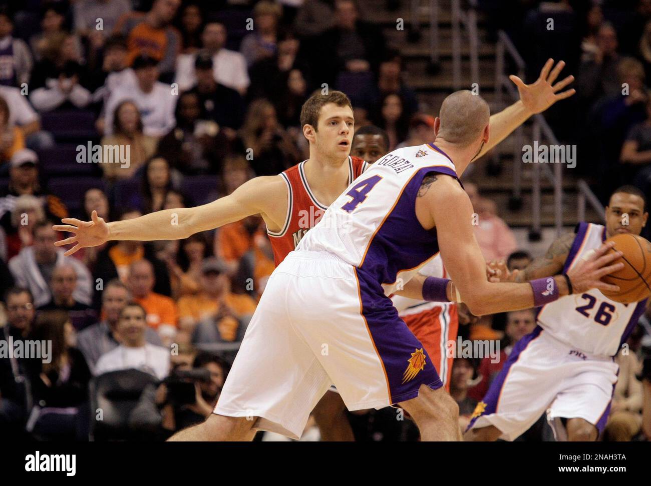 Milwaukee Bucks' Jon Leuer, rear, against Phoenix Suns' Marcin Gortat, front, of Poland, in an NBA basketball game Sunday, Jan. 8, 2012, in Phoenix. (AP Photo/Paul Connors) Stockfoto