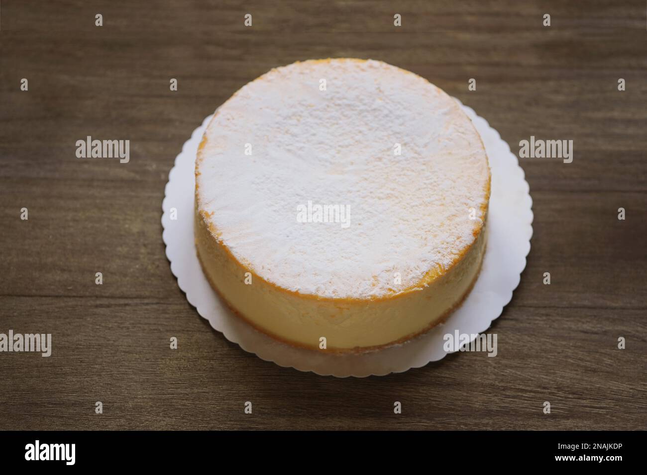 Ganze Käsekuchen oder deutsche Käsecremesorte oder Torte auf Rustikaler Holztisch Stockfoto