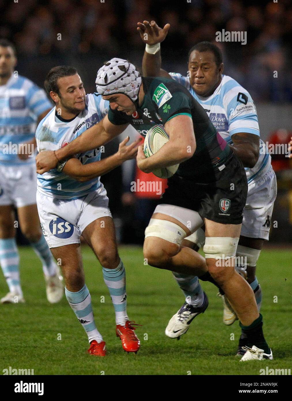Racing Metro 92 players Jone Qovu Nailiko, right, and Mathieu Loree, left, try to stop London Irish player Bryn Evans during their Heineken European Cup rugby union match in Colombes west of Paris, Saturday Dec. 10, 2011. (AP Photo/Remy de la Mauviniere) Stockfoto