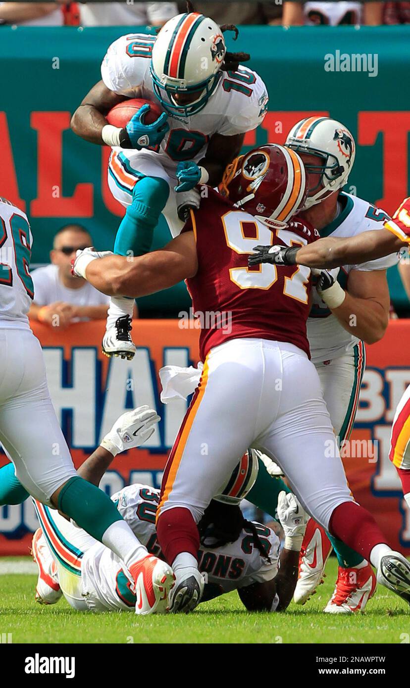 Miami Dolphins wide receiver Clyde Gates (10) leaps for yardage during the second half an NFL football game against the Washington Redskins, Sunday, Nov. 13, 2011, in Miami. The Dolphins defeated the Redskins 20-9. (AP Photo/Wilfredo Lee) Stockfoto