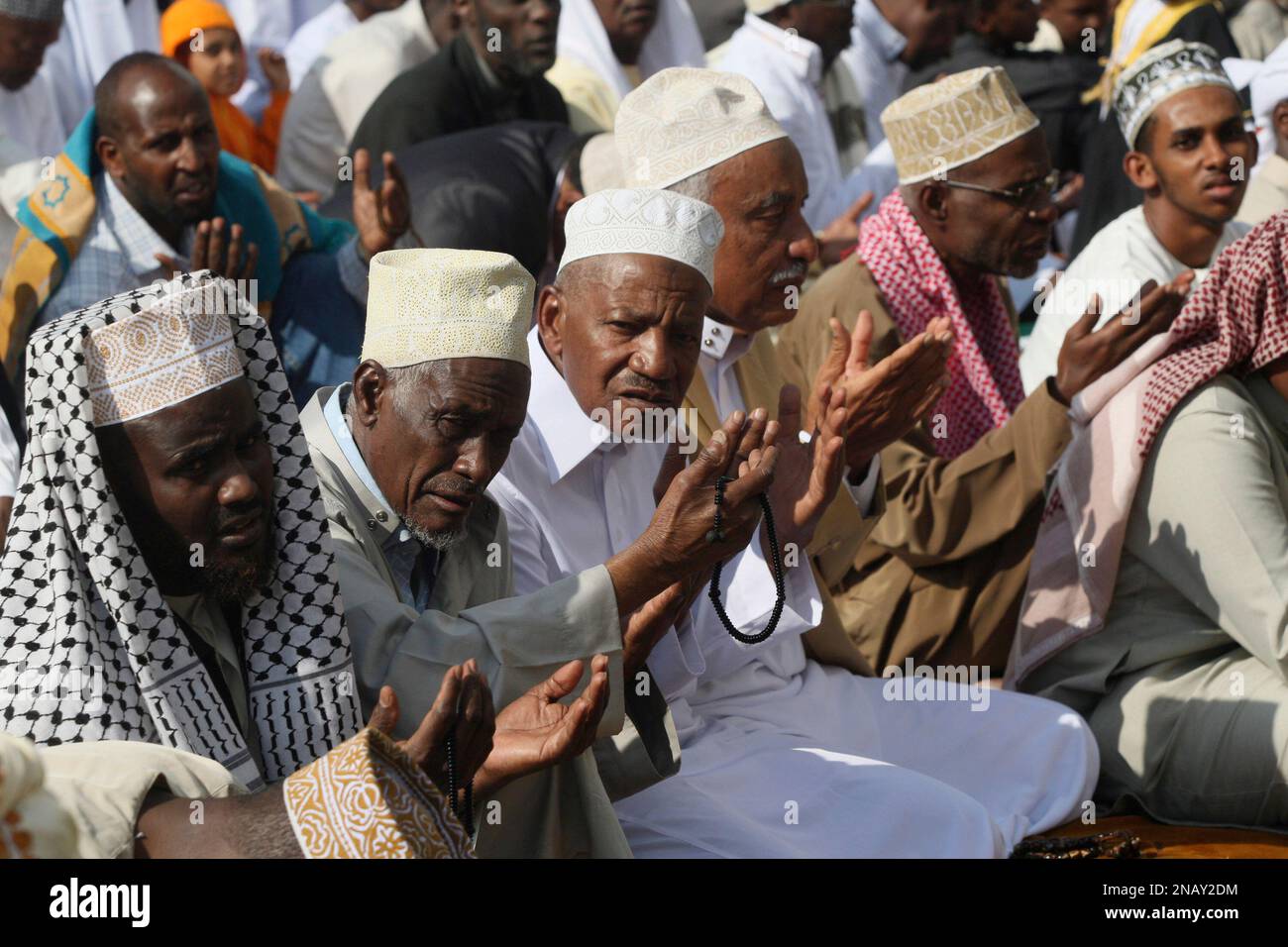 Kenyan Muslims raise their hands in prayers at Noor Mosque in Nairobi