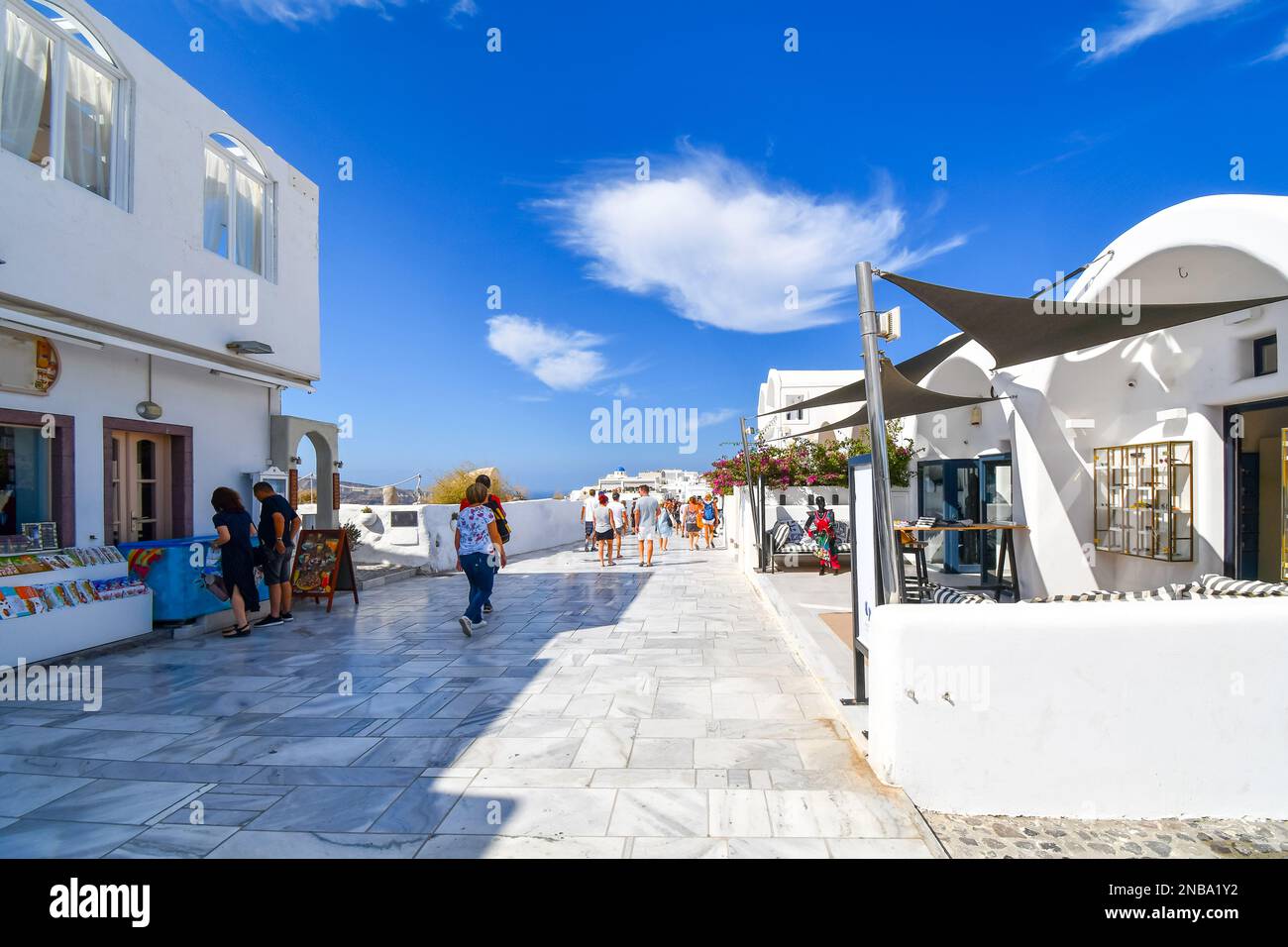 Die weiß getünchte Terrasse mit Geschäften und Cafés mit Blick auf das Meer auf der Insel Oia, Santorin, Griechenland. Stockfoto