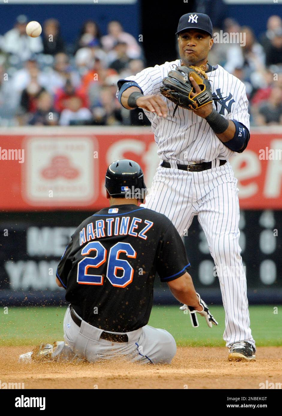 New York Mets' Fernando Martinez (26) is out at second as New York Yankees second baseman Robinson Cano atttempts to complete a double play during an interleague baseball game Sunday, May 22, 2011 at Yankee Stadium in New York. (AP Photo/Bill Kostroun) Stockfoto