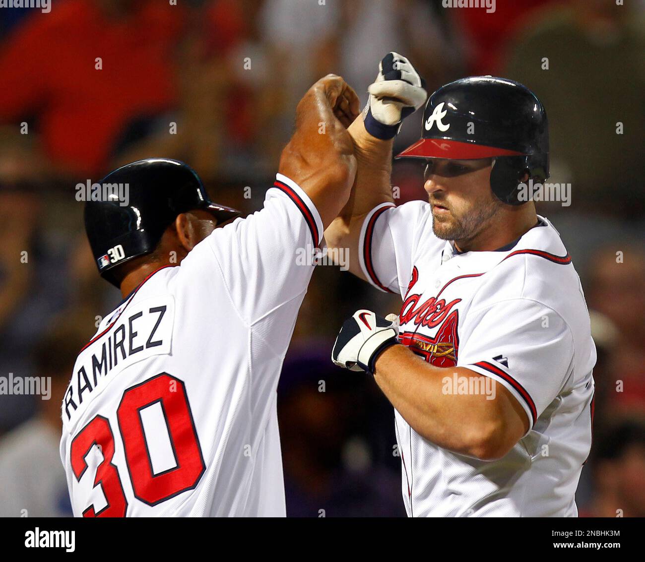 Atlanta Braves' Dan Uggla, right, celebrates with Wilkin Ramirez (30) after hitting a two-run home run in the eighth inning of a baseball game against the Colorado Rockies in Atlanta Wednesday, July 6, 2011. Atlanta won 7-1. (AP Photo/John Bazemore) Stockfoto