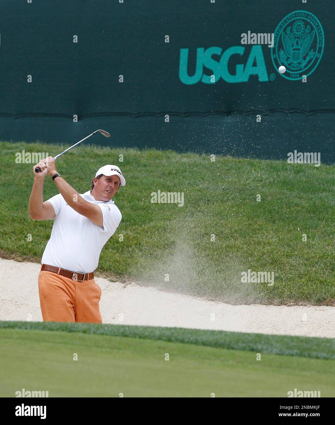Phil Mickelson chips out of the bunker to the 18th green during a practice round for the U.S. Open Championship golf tournament in Bethesda, Md., Tuesday, June 14, 2011. (AP Photo/Matt Slocum) Stockfoto