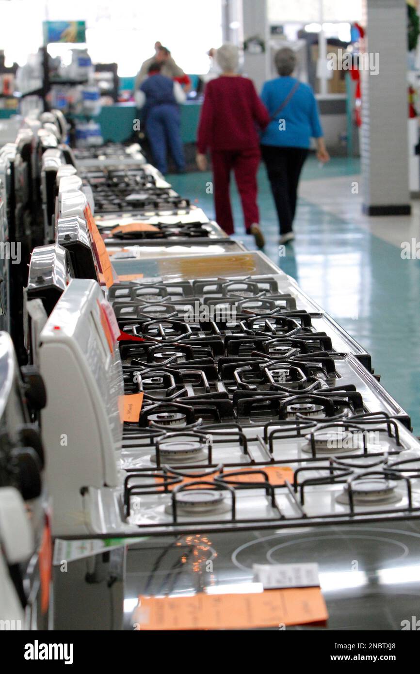 In this Dec. 24, 2010 photograph customers walk past a row of electric