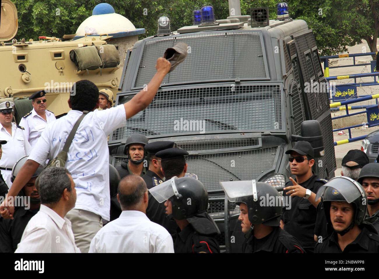 A protester with writing on his shirt in arabic reading 