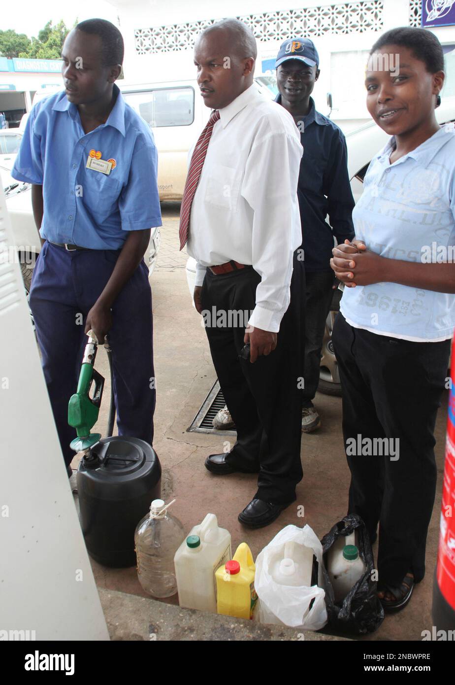 Motorists scramble for fuel with plastic jerry cans at a Nairobi petrol
