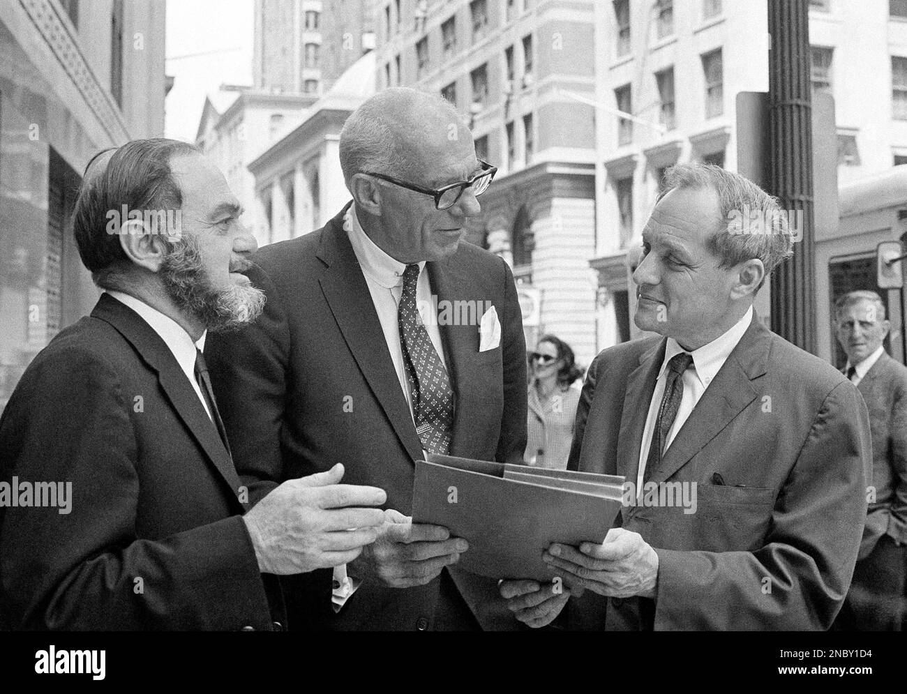 Dr. Benjamin Spock, center, chats with his lawyers outside Federal ...
