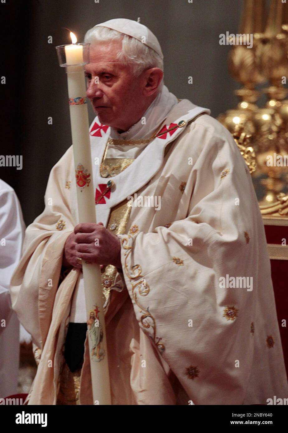 Pope Benedict XVI holds a candle as he celebrates the Easter Vigil mass