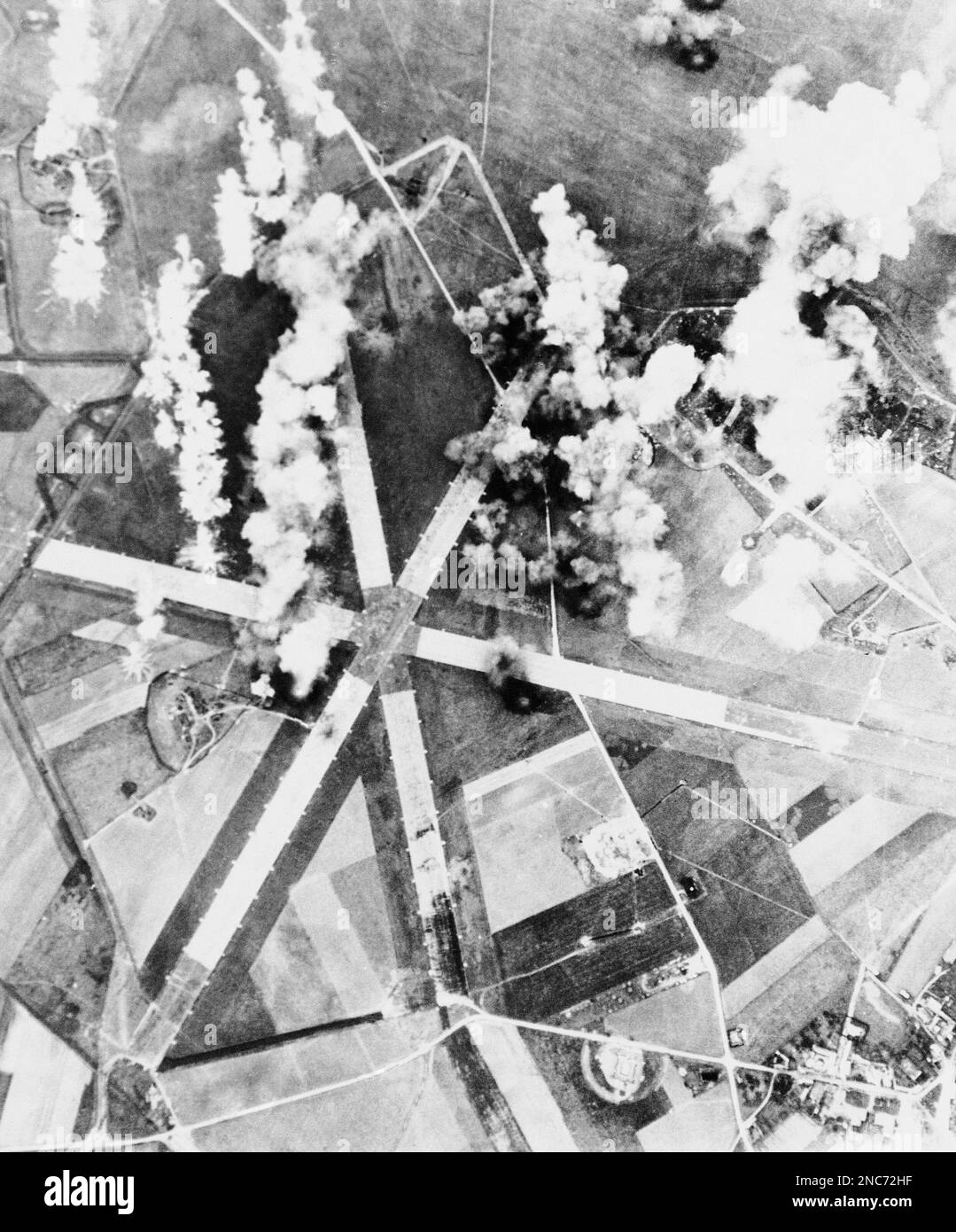 Bombs from American Marauder (B-26) medium bombers burst on a German ...