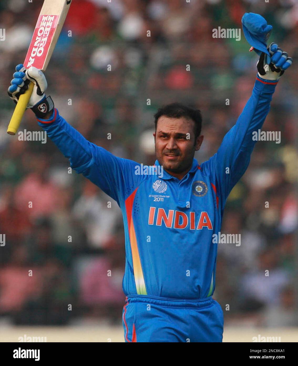ALTERNATE CROP OF WCCJW140 India's Virender Sehwag reactsd after he hit a century in the opening cricket World Cup match against Bangladesh in Dhaka,Bangladesh, Saturday, Feb.19, 2011. (AP Photo/ Pavel Rahman) Stockfoto