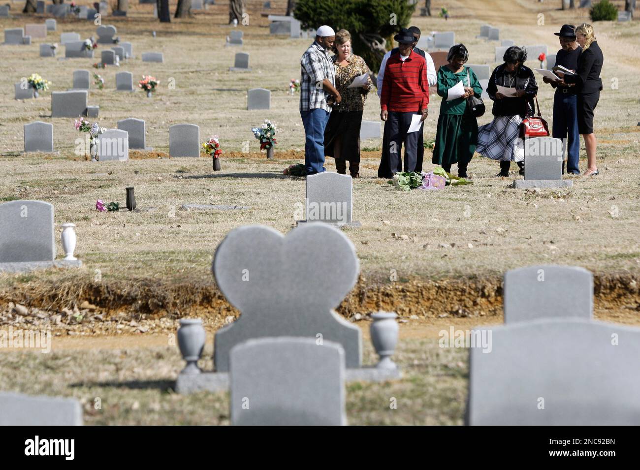 Larry Sims, center in red, is joined by DNA exoneree Billy Smith, from ...