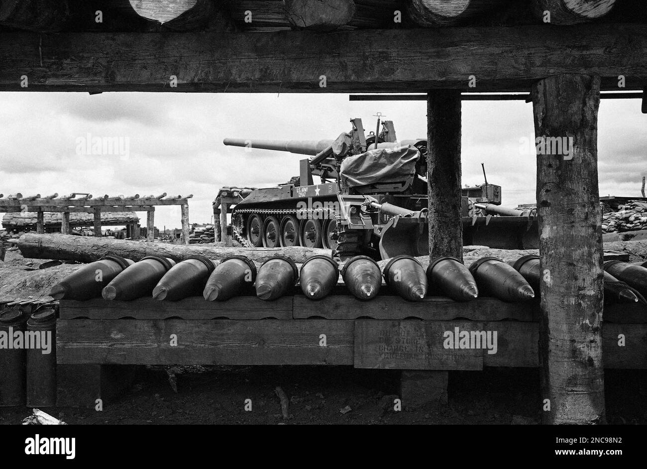 Shells for the big 175mm self-propelled gun in background lie ready ...