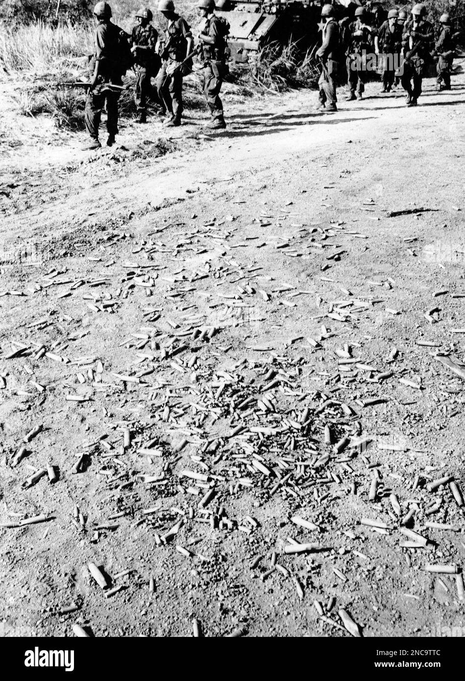 Empty cartridge casings litter the road between An Loc and Min Thanh