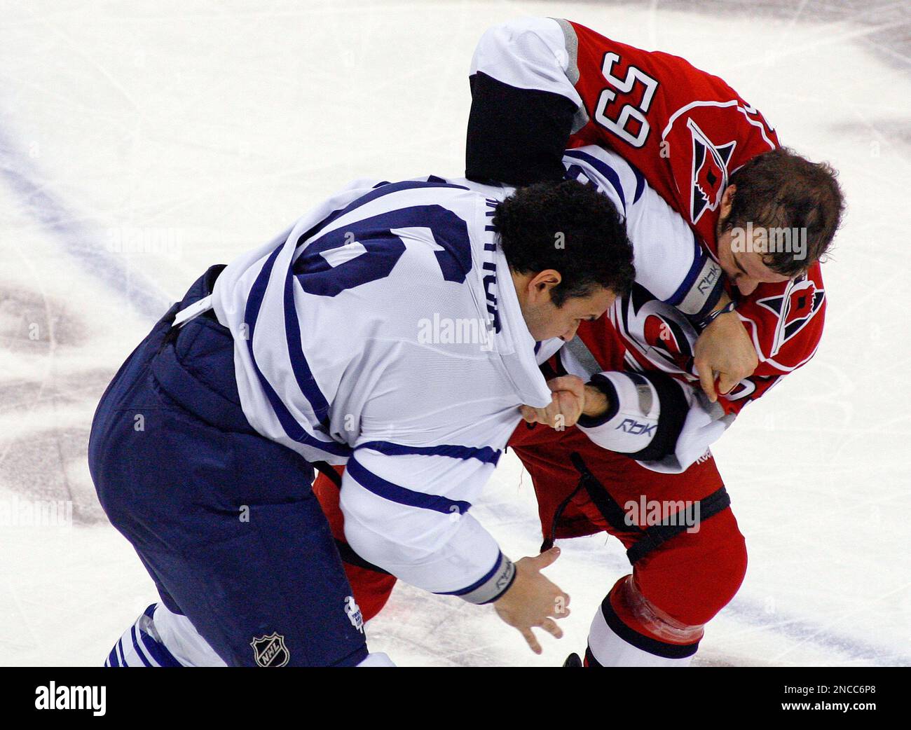 Carolina Hurricanes' Chad LaRose (59) and Toronto Maple Leafs' Clarke MacArthur (16) tussle during the first period of an NHL hockey game in Raleigh, N.C., Monday, Jan. 24, 2011. (AP Photo/Karl B DeBlaker) Stockfoto