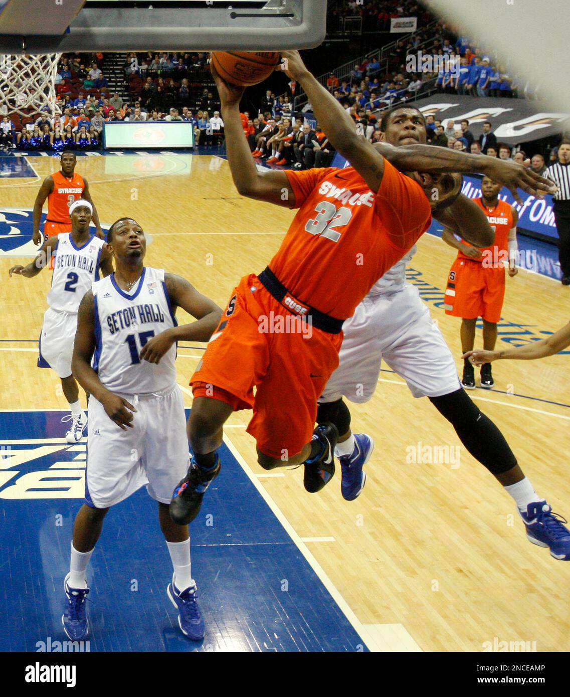 Seton Hall's Jeff Robinson, back, fouls Syracuse's Kris Joseph (32) as Joseph goes up for a shot during the second half of an NCAA college basketball game at the Prudential Center in Newark, N.J., Saturday, Jan. 8, 2011. Syracuse defeated Seton Hall 61-56. (AP Photo/Rich Schultz) Stockfoto