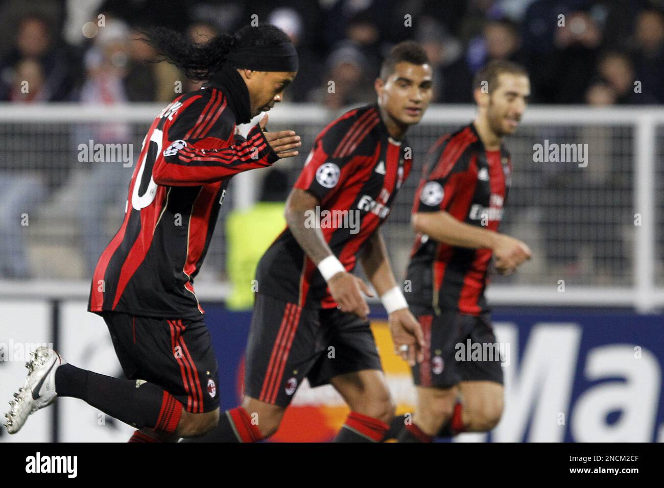AC Milan's Ronaldinho, left, celebrates after he scored a goal against