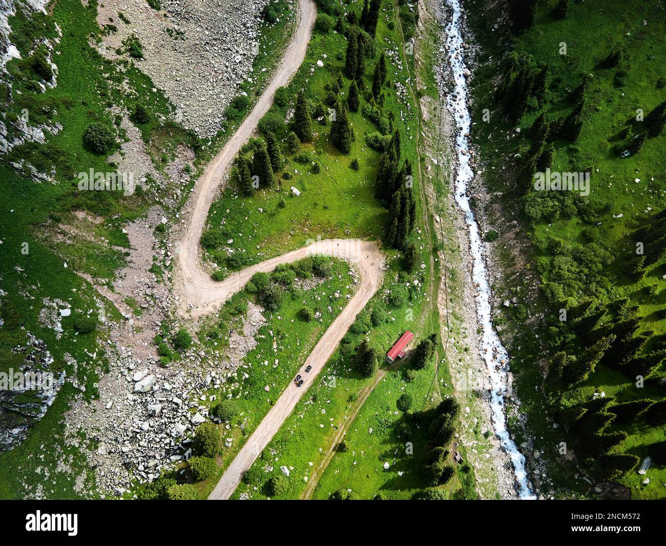 Wunderschöne Landschaft der Kiesberge und des Flusses mit grünem Hügel in Almaty, Kasachstan. Outdoor- und Wanderkonzept, Luftdrohne Top-Down-Aufnahme Stockfoto