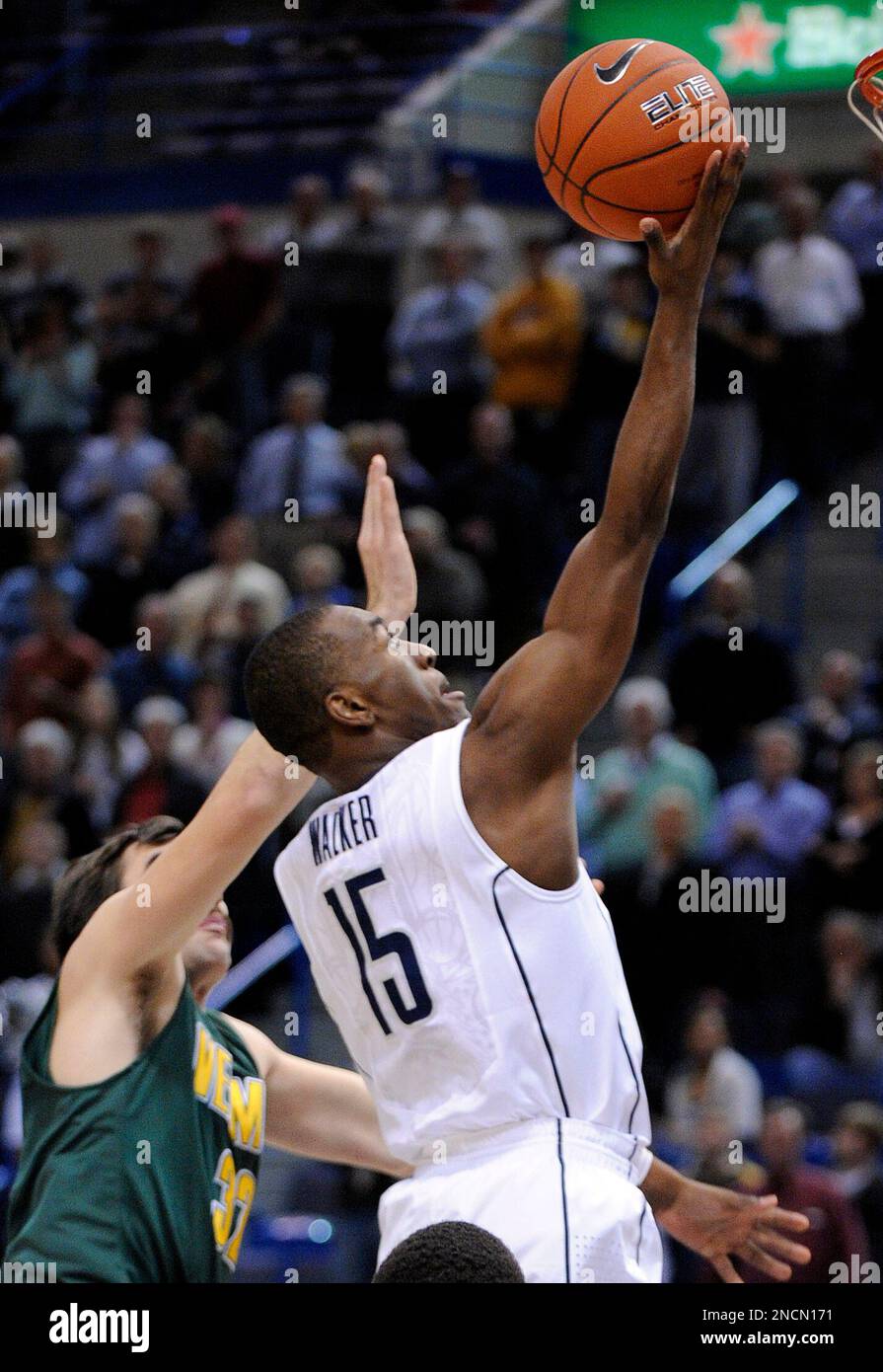 Connecticut's Kemba Walker, right, drives past Vermont's Evan Fjeld during the first half of an NCAA college basketball game in Hartford, Conn., on Wednesday, Nov. 17, 2010. (AP Photo/Fred Beckham) Stockfoto