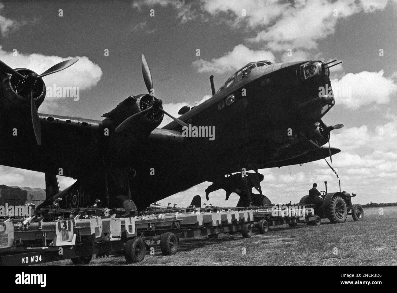 In this British Official Photo, on a British airfield, firebombs are loaded into an R.A.F. plane before an attack on industrial Germany. The bomb-trolley with its load of containers to be fitted into the aircraft, July 20, 1942. (AP Photo/British Official Photo) Stockfoto