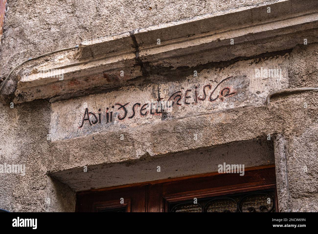 Uralte Schrift, eingraviert in den Architekten eines mittelalterlichen Hauses im Dorf Contigliano. Contigliano, Provinz Rieti, Umbrien, Italien, Europa Stockfoto