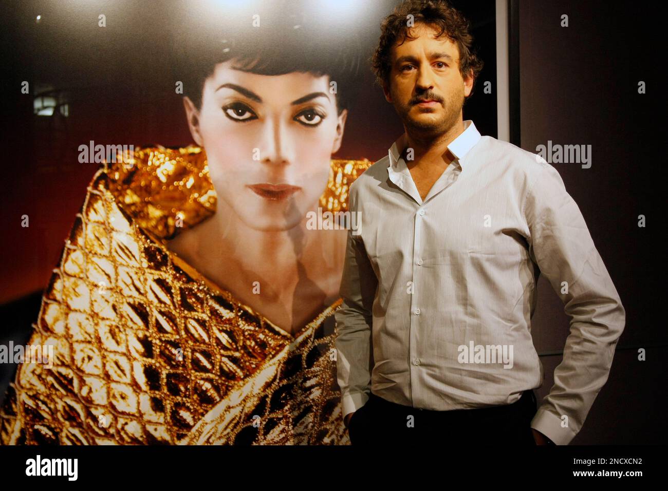 French photographer Arno Bani stands next to a previously unpublished portrait of Michael Jackson displayed at Drouot auction house in Paris, Friday Oct. 15, 2010. The portraits were shot in 1999 and will be auctioned on Monday Dec 13 in Paris. Jackson contacted Bani, only 23 years old at the time, after seeing his fashion photography in a newspaper. (AP Photo/Francois Mori) Stockfoto